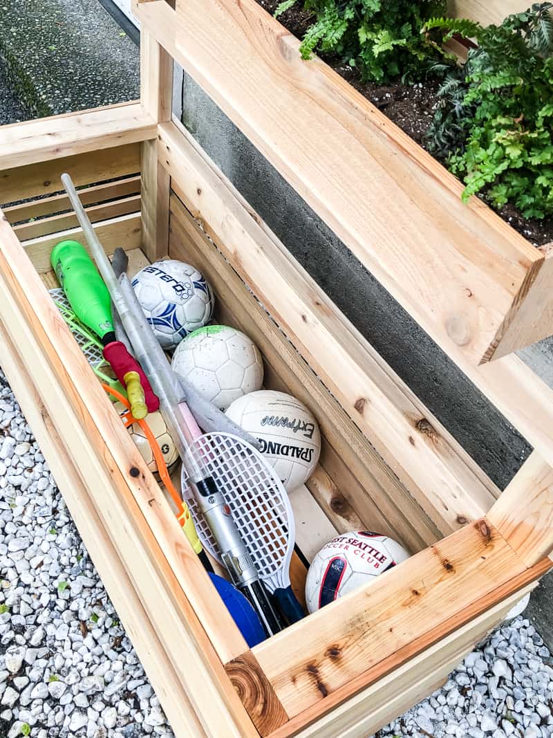 toys inside lower box of vertical garden wall planter