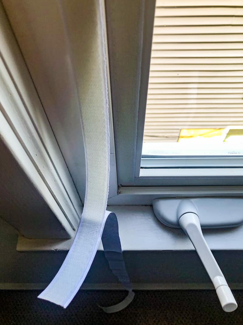 applying adhesive velcro to window frame for casement window air conditioner seal