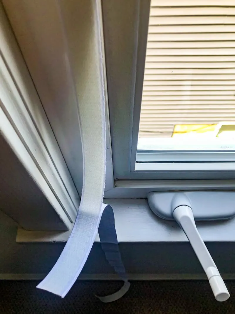 applying adhesive velcro to window frame for casement window air conditioner seal