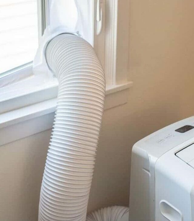 portable air conditioner in crank out window with fabric screen around opening