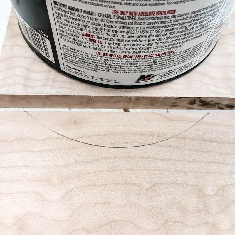 marking the curve of the drawer pull with a gallon paint can