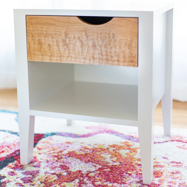 DIY nightstand with white frame and curly maple drawer front on colorful rug