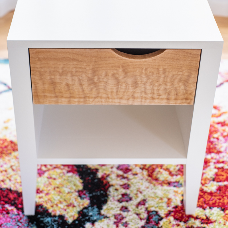 front view of DIY nightstand with white frame and curly maple drawer front