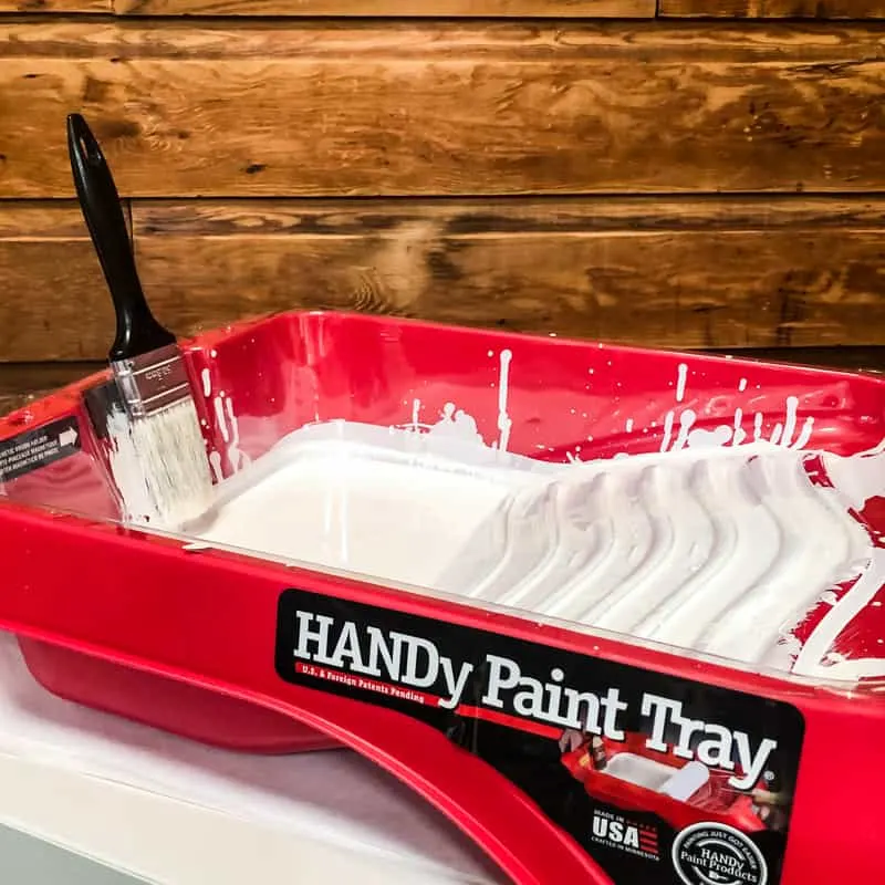 HANDy Paint tray holding white paint and paint brush