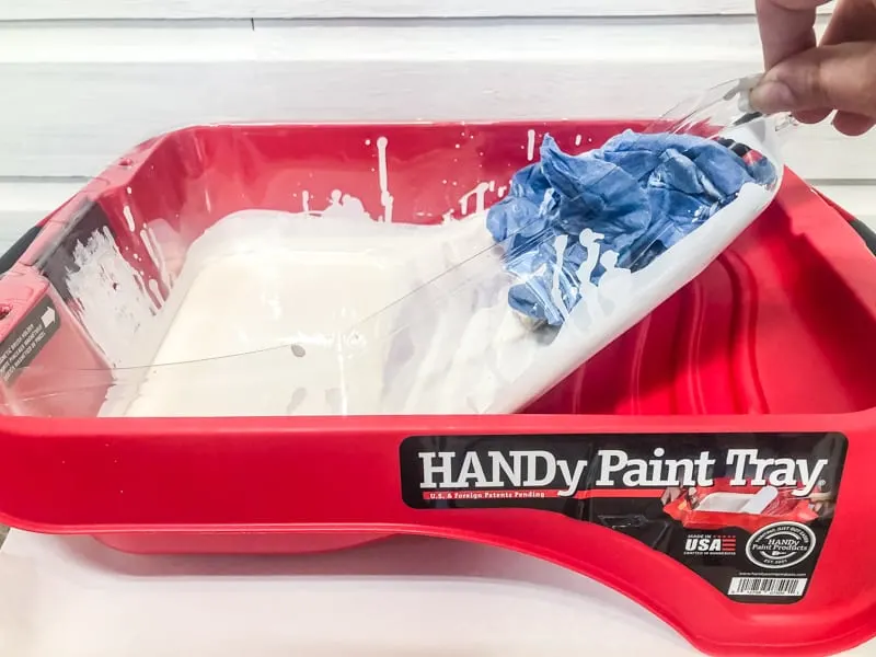removing paint tray liner for easy clean up after painting wood paneling