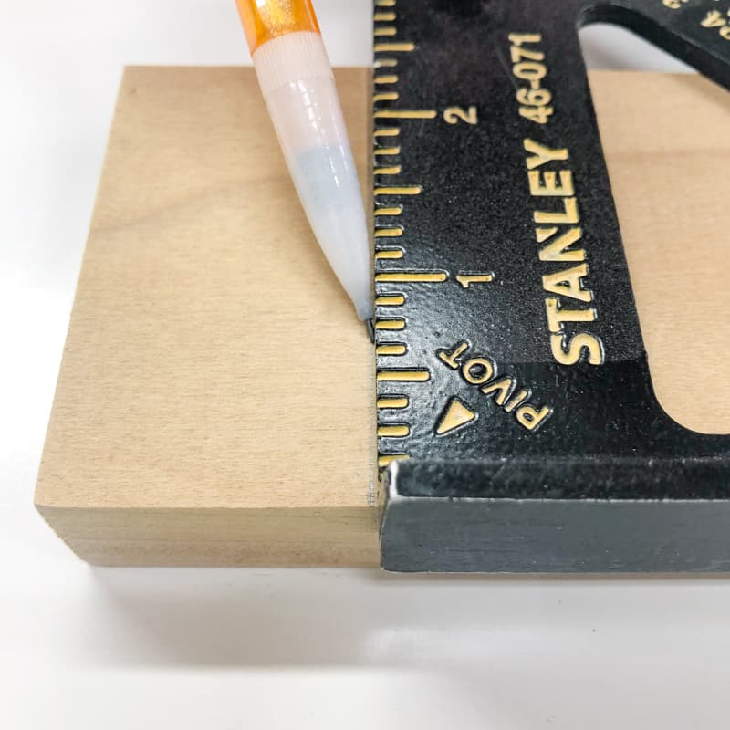 marking the cut line with a mechanical pencil and speed square