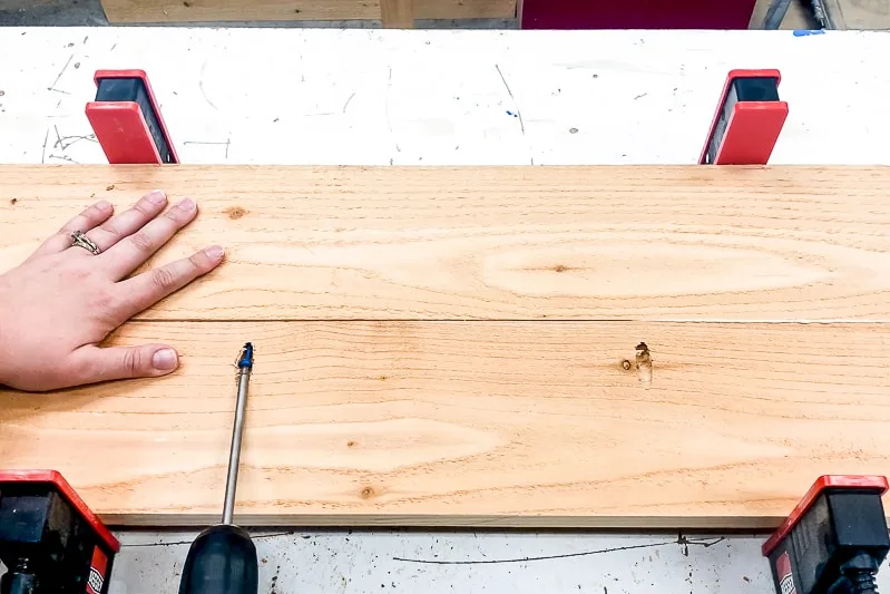 screwing together both sides of the deck railing table with pocket hole screws