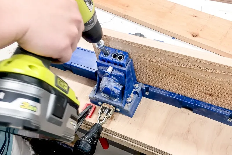 drilling pocket holes along the length of one board for the balcony railing table