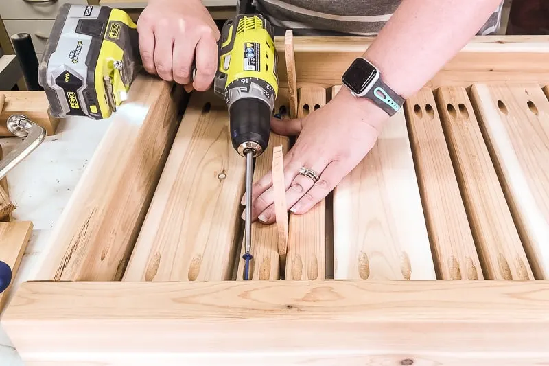 screwing the slats to the frame of the outdoor coffee table frame