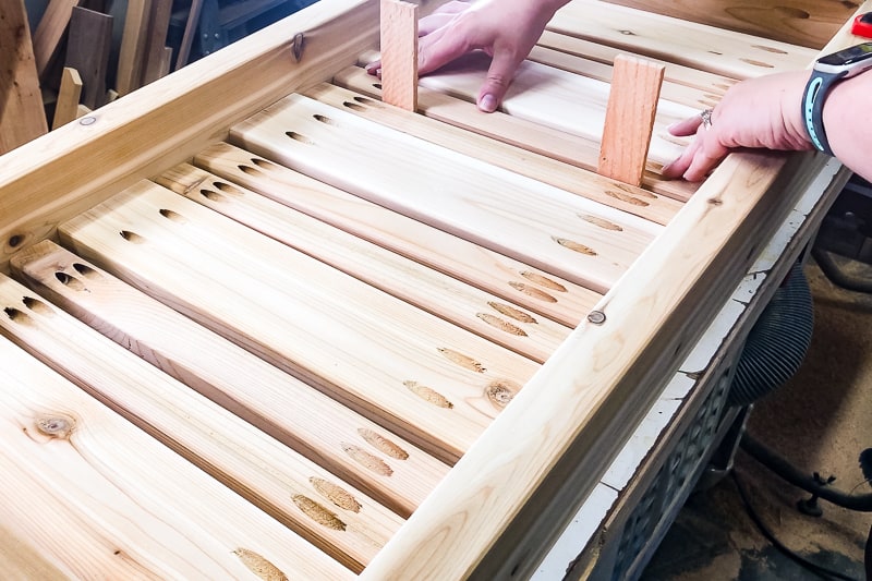 using spacers to get correct spacing between DIY outdoor coffee table slats