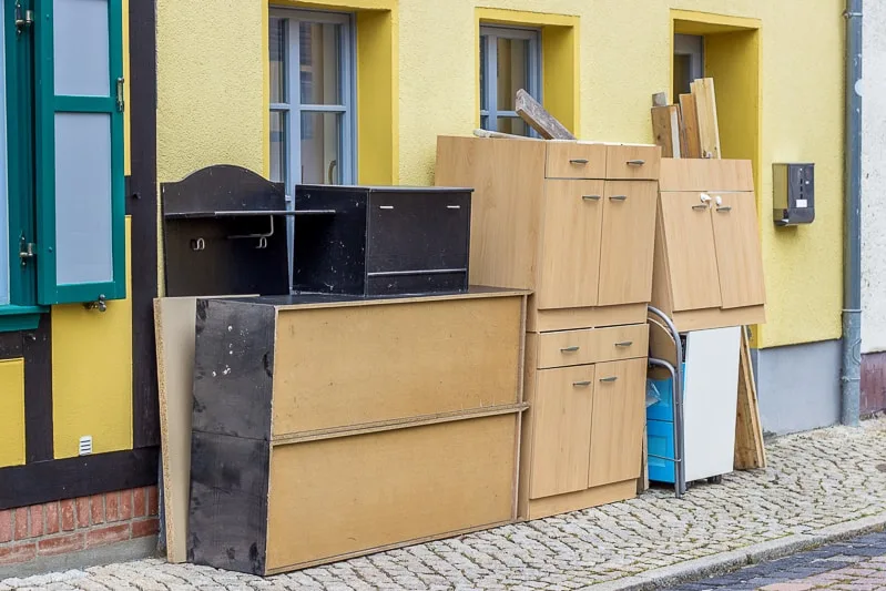free furniture piled up on the side of the road