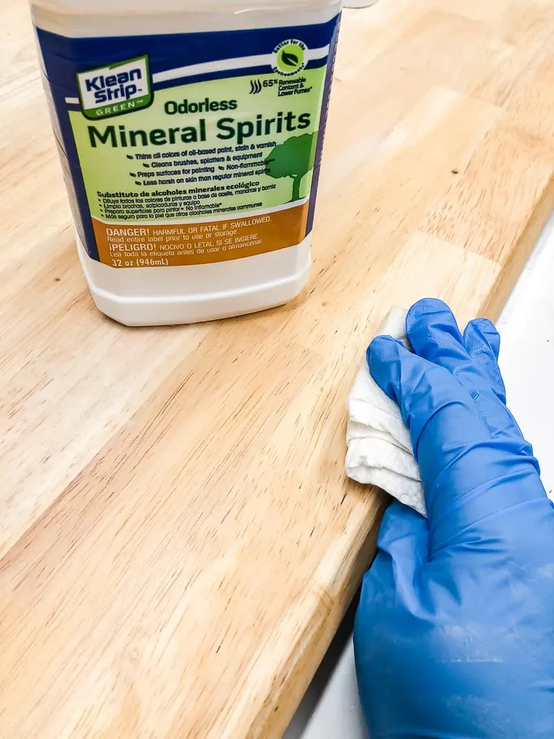 wiping down table to be stained with mineral spirits