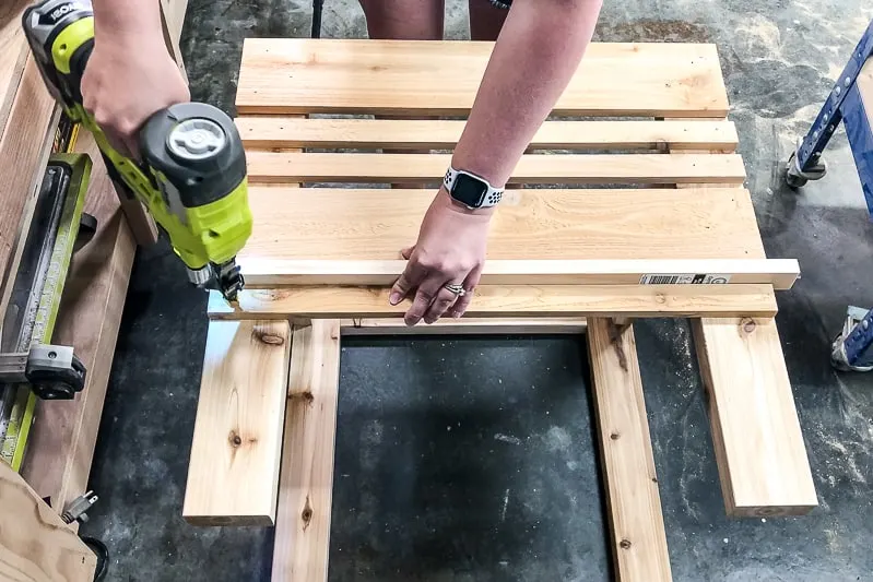 attaching slats to sides of umbrella stand table base with brad nails