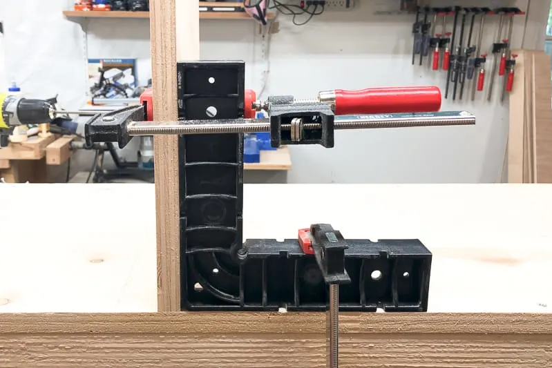 corner clamp holding center divider of lumber cart in place