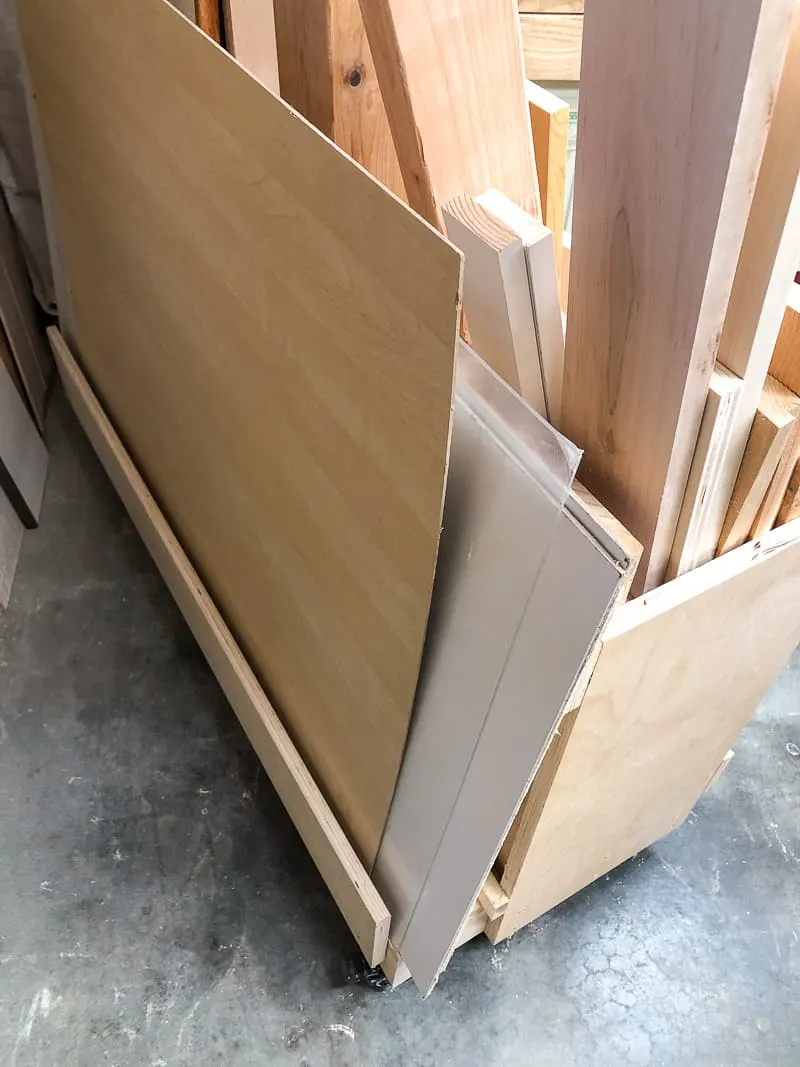 plywood sheets stored on the back of a DIY lumber cart