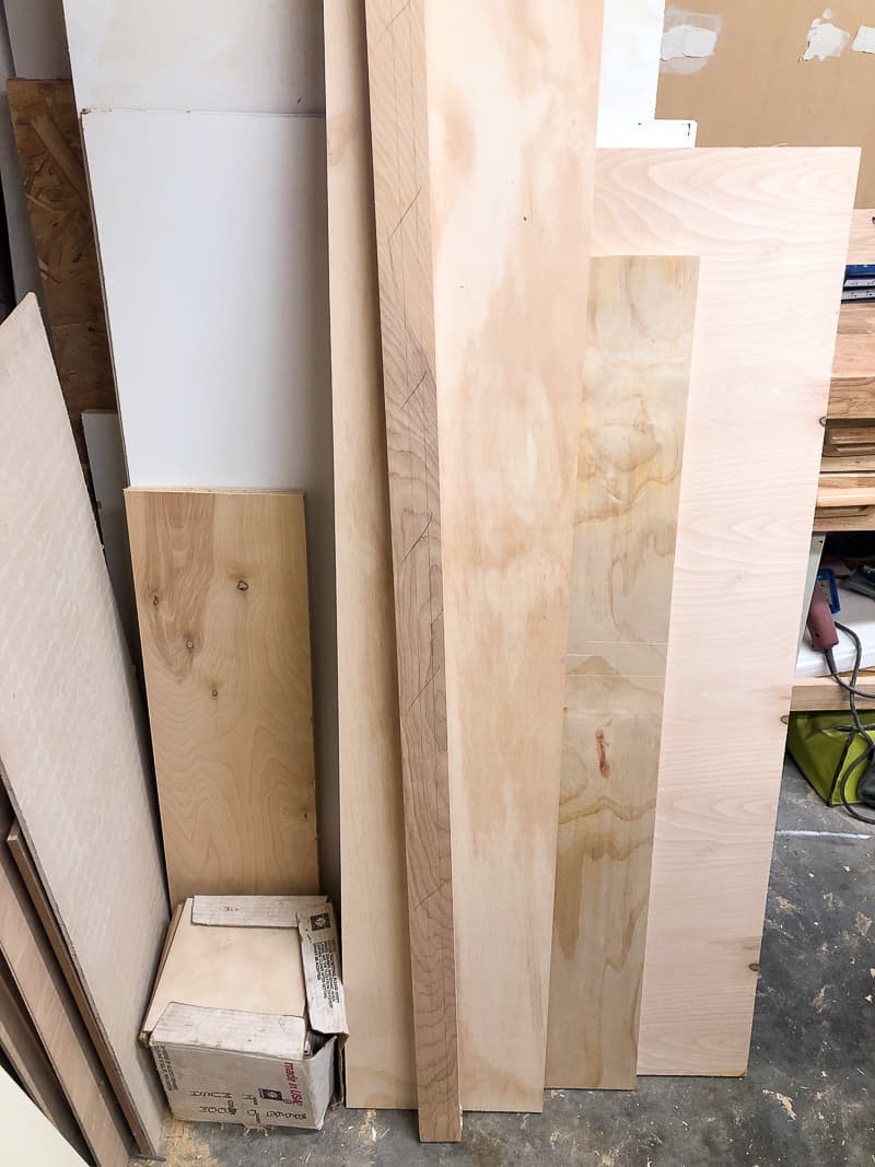 plywood stacked against the wall in the workshop