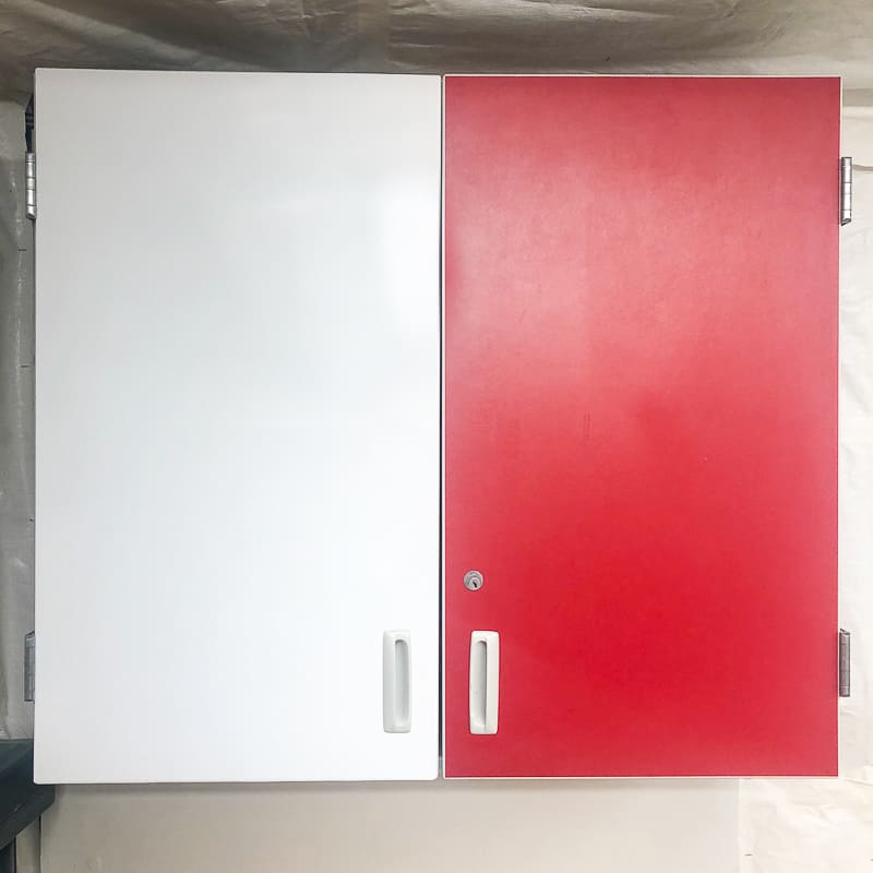 cabinet with one red door and one white contact paper covered side