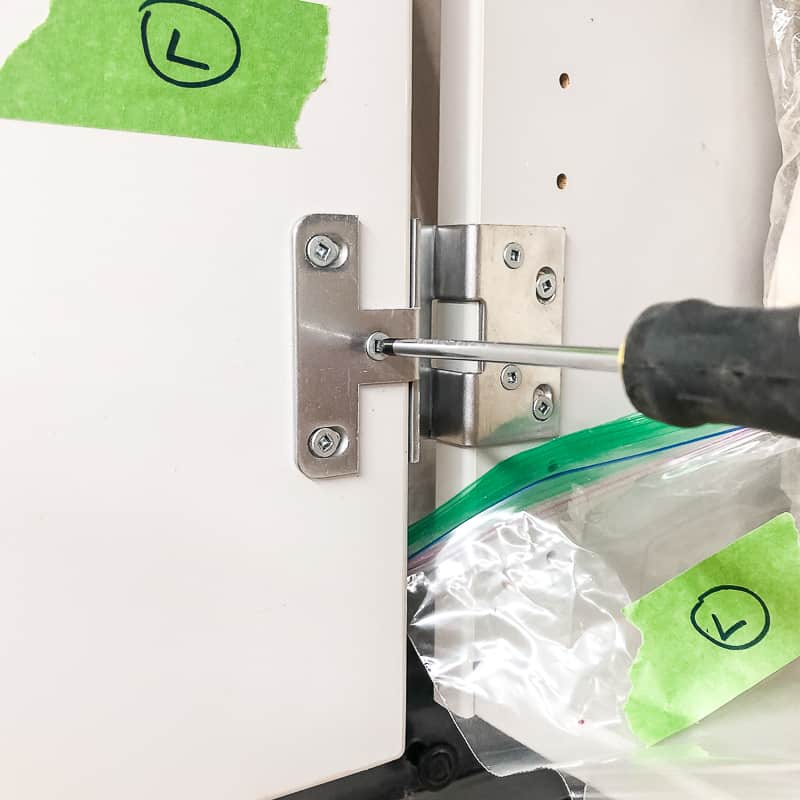 label on cabinet door and plastic bag before removing cabinet door