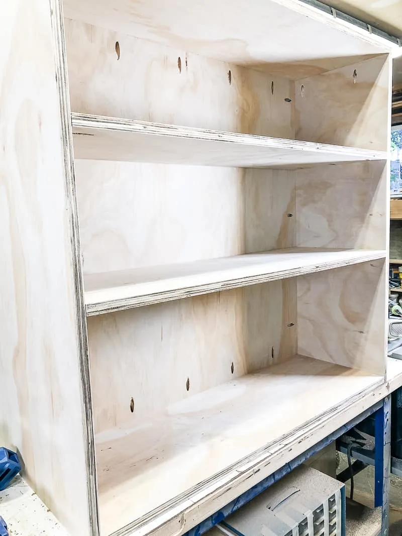 three shelves on one side of the DIY workbench installed