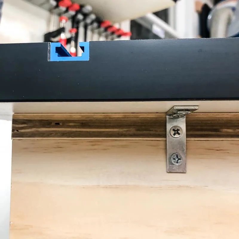 T track top attached to workbench with L brackets