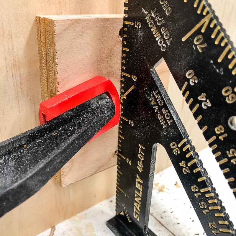 clamping scrap wood to side of DIY workbench for casters