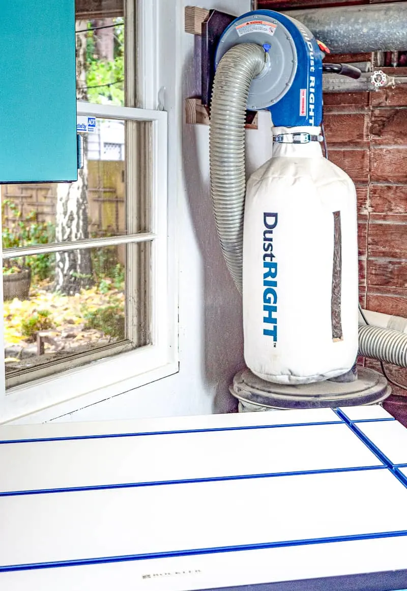 rolling workbench under window with wall mount dust collector