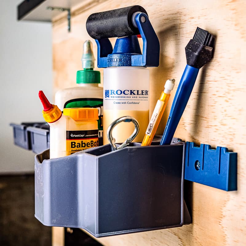 glue caddy and screw bins on side of mobile workbench