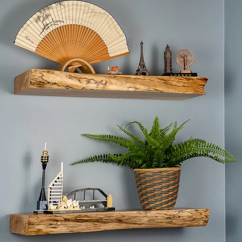 live edge floating shelves with travel souvenirs