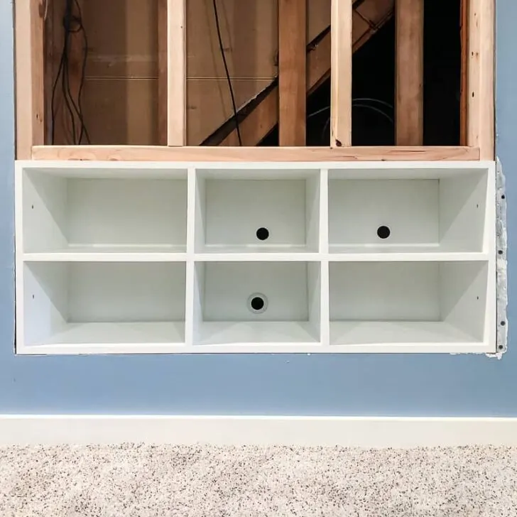 built in entertainment center shelves installed in opening in wall