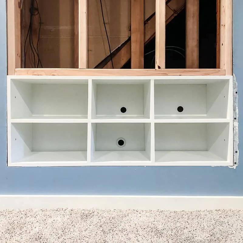built in entertainment center shelves installed in opening in wall