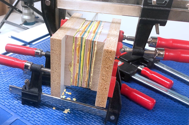 layers of wood and glue clamped together for DIY wooden candle holder