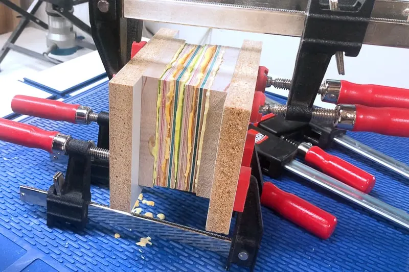 layers of wood and glue clamped together for DIY wooden candle holder