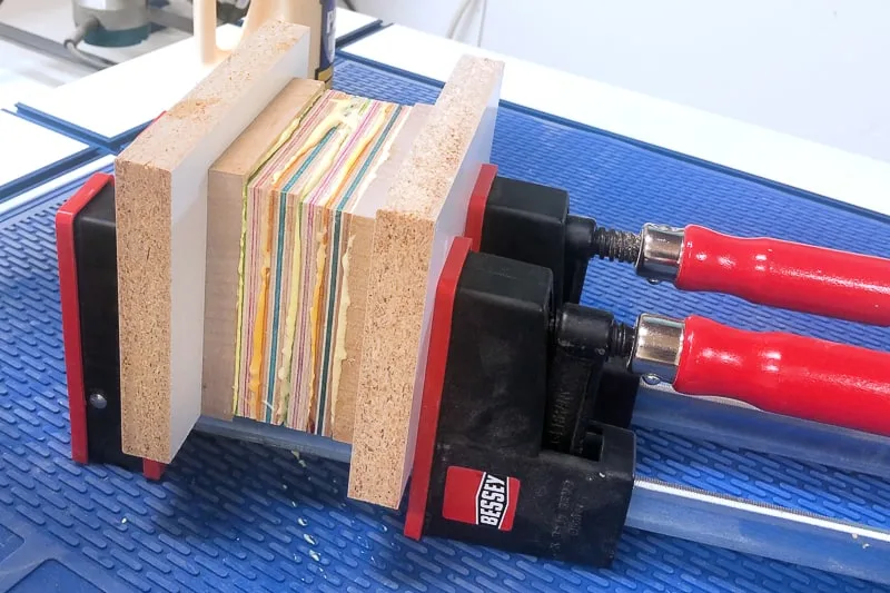 layers of skateboard veneer in parallel clamps