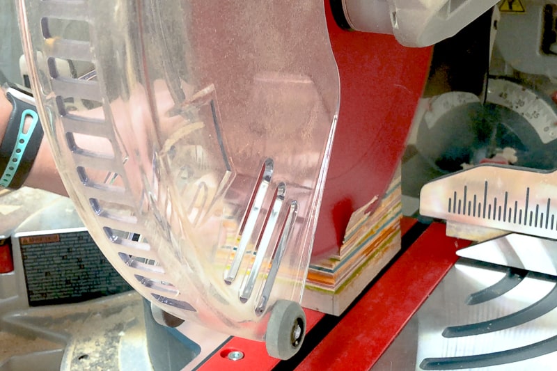 trimming excess from DIY wooden candle holder with a miter saw