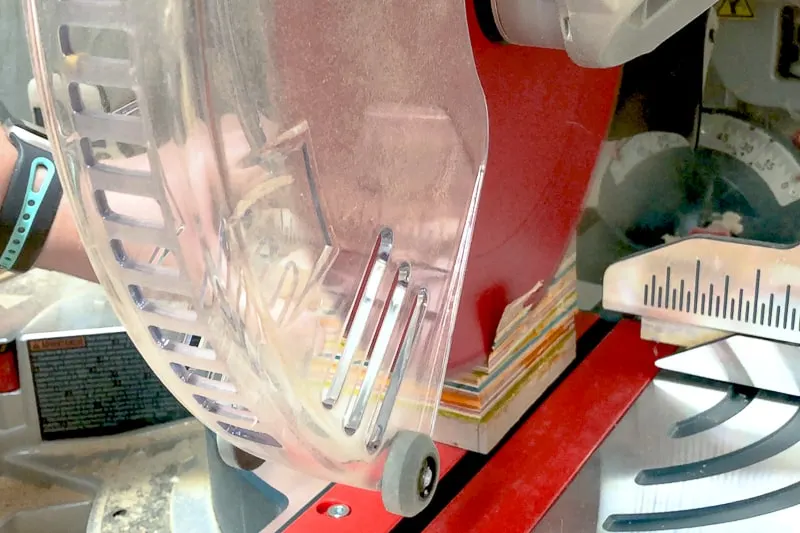 trimming excess from DIY wooden candle holder with a miter saw