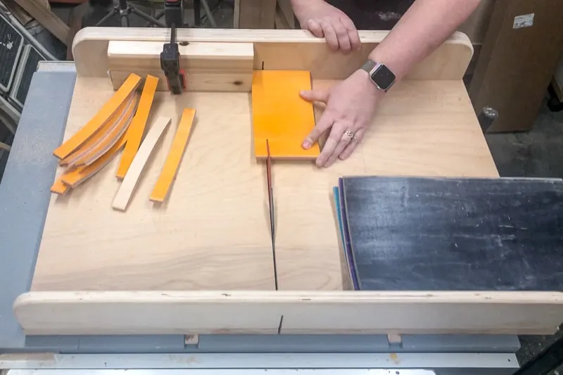 cutting strips of skateboard on a crosscut sled with the table saw