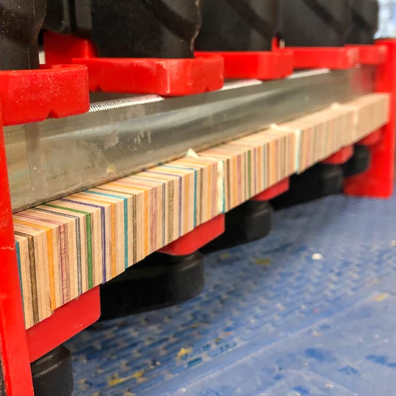 skateboard wood in clamps waiting for wood glue to dry