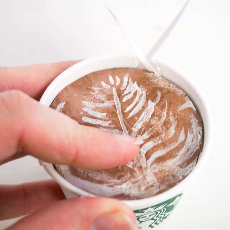 adding the painted latte circle to the top of the Starbucks cup