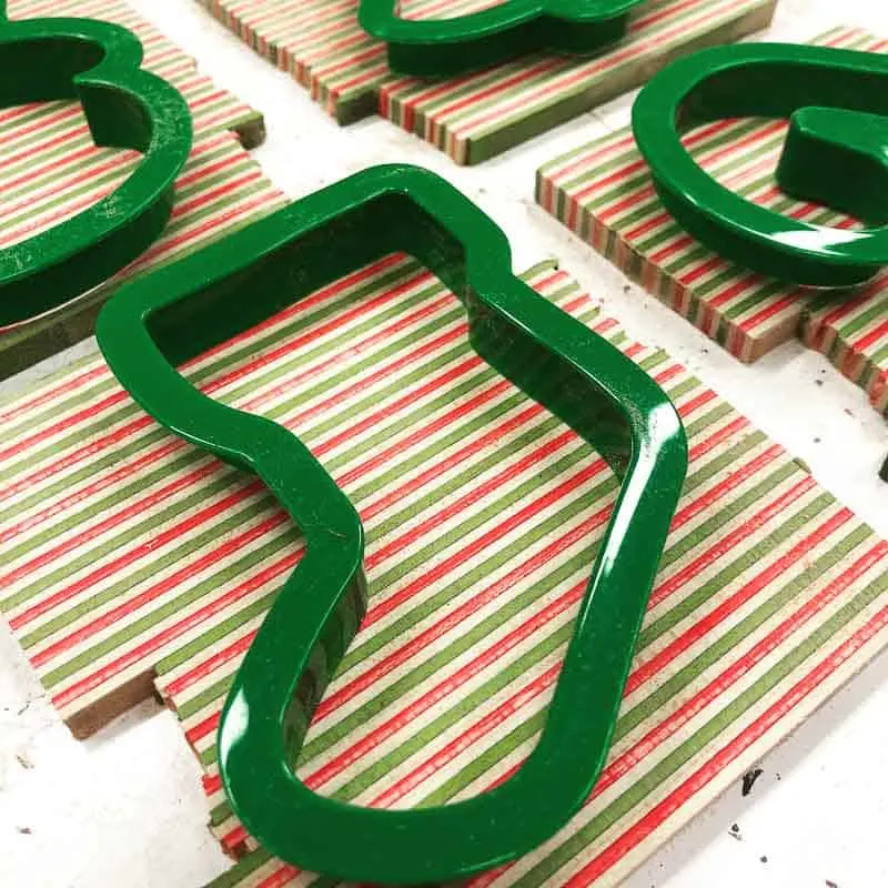 cookie cutters used as stencils for wooden ornaments