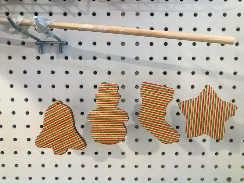 hanging wooden ornaments from a dowel to dry