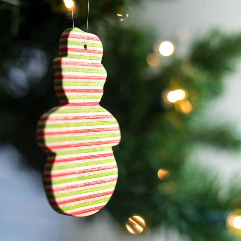 snowman wooden ornament on Christmas tree