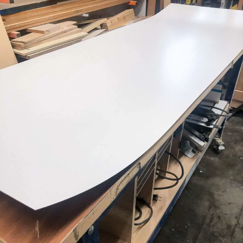 cut laminate sheet on workbench
