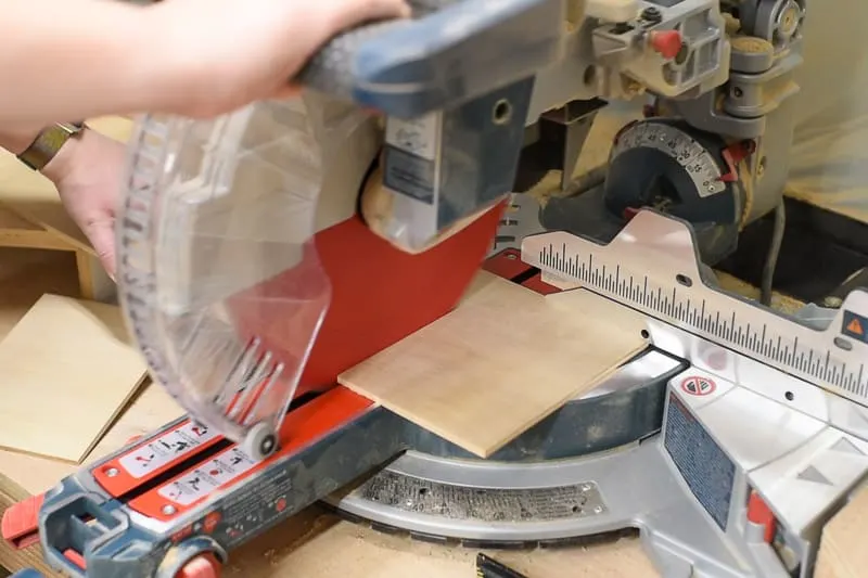 cutting dividers for DIY drawer organizer out of ¼" plywood on the miter saw