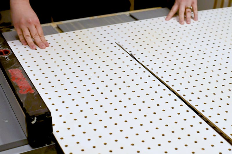 cutting pegboard for DIY drawer organizer on the table saw.