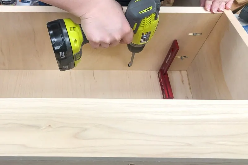 Attach the shelf of the DIY kids bookshelf to the back and sides with pocket hole screws.