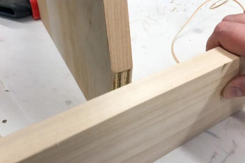 testing fit of front piece of bookshelf after applying edge banding
