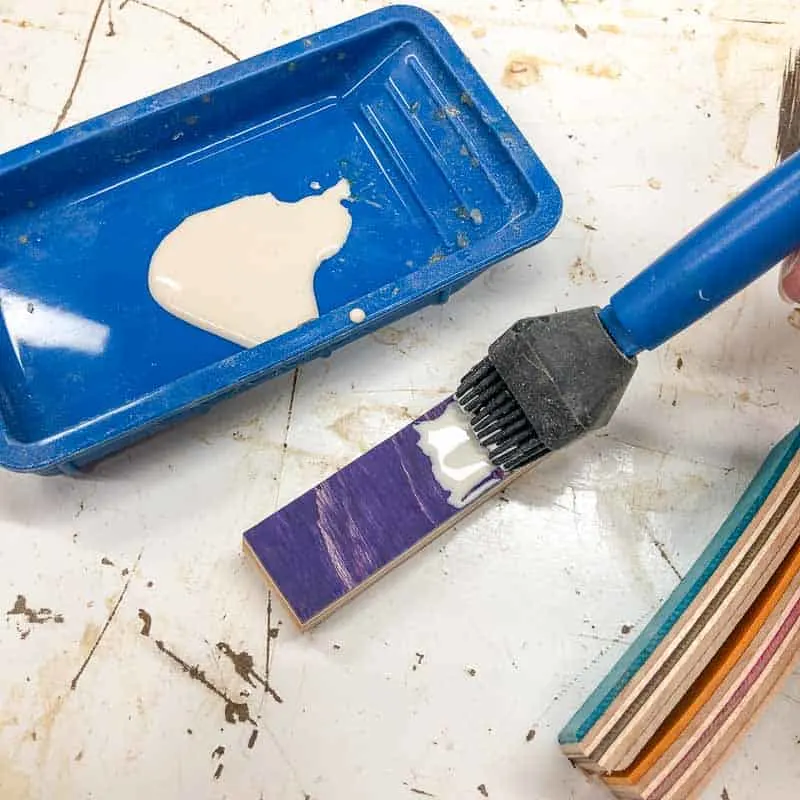 applying wood glue to skateboard wood strips