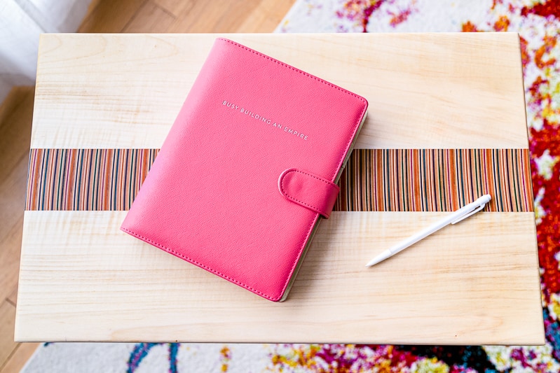 laptop stand with colorful recycled skateboard center stripe with day planner and pencil on top