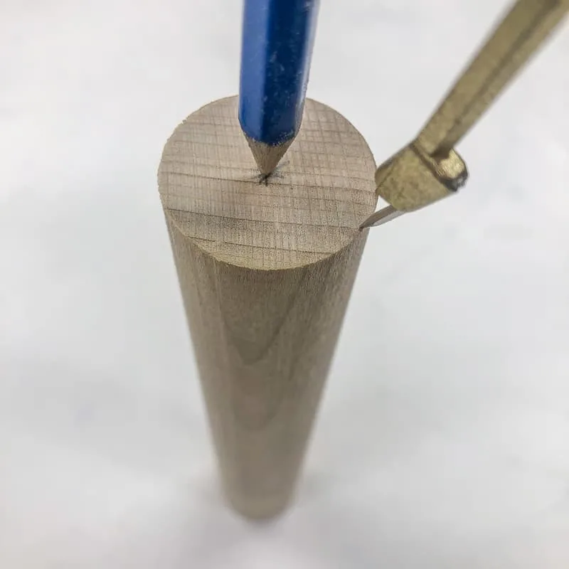 marking the center of a wooden dowel end with a compass