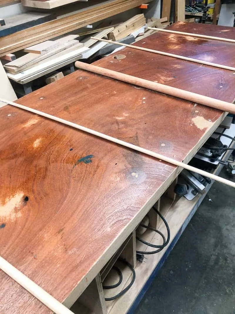 wooden dowels on workbench surface before laminate installation